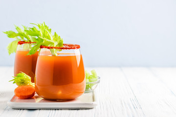 Vegan carrot celery juice in glasses. Copy space.