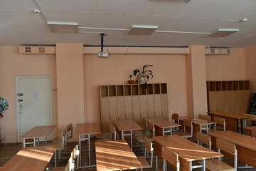 School classroom with desks and a projector
