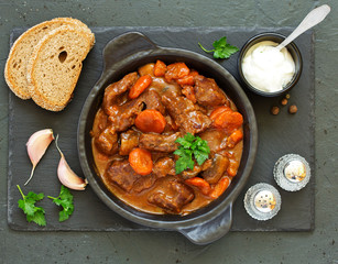 Beef stew in Burgundy. With carrots, onions, peas and champignons in wine. View from above.