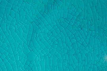 Blue background. Cracks in ceramics porcelain, macro