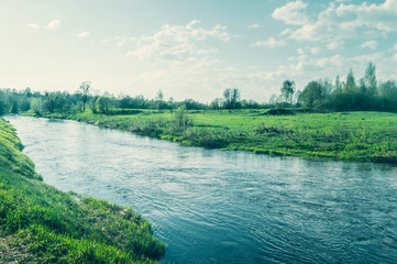Beautiful scenic landscape with river and green banks