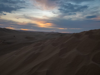 Fototapeta na wymiar Sunset at the desert, multicolored sky at golden hour, Ica, Peru