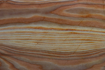 Fragment of a wooden cutting board with scratches. Wood texture