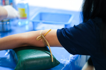 Doctor or nurse hands in medical blood collecting from a patient , Laboratory with nurse taking a blood sample from patient.