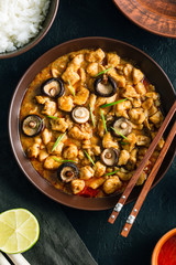 Panang Gai, Delicious spicy Thai food of chicken with shiitaki mushrooms on a black background