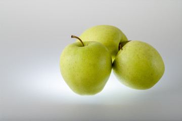 Long-stored sweet apples of the variety Golden delicious on neutral background