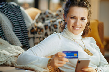smiling woman looking for sweater at fashion online shop