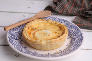 Delicious three cheese quiche in colored background