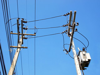 High voltage cables and transformers on the pole Connecting the power cord to the transformer on a...