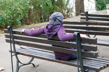 girl sitting on a park bench