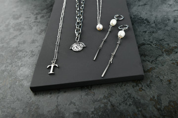 silver jewelry on a marble background. Jewelry for all lovers. View from above.