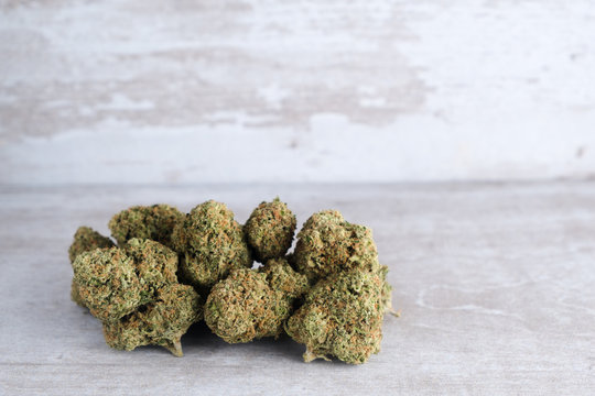 Recreational marijuana on a white stone background after Illinois passes a law to legalize weed sales and pardon weed related prisoners. Flower trichomes and kief made beautiful during plant curing 