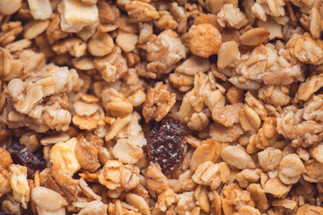 Useful and tasty muesli with nuts, rasins and flakes. Selective focus macro shot with very shallow depth of field. Healthy and vegetarian lifestyle