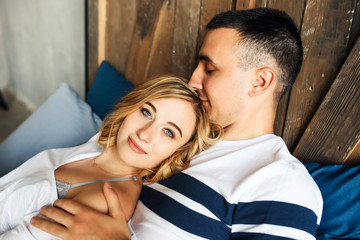 Young couple in love laughing in bed