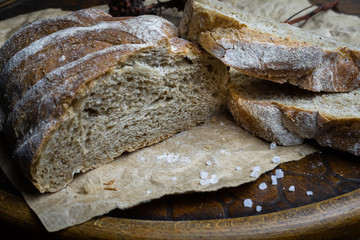 Farm fresh bread with coarse salt on a vintage wooden chair