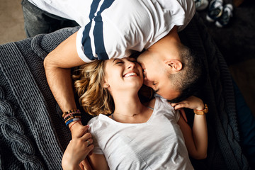 Young couple in love laughing in bed