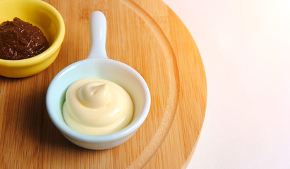 delicious sauce in a light blue bowl on a cutting board. tasty exotic cuisine and spicy spice concept