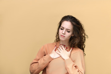 Portrait of a young beautiful woman wearing sweatshirt posing isolated over yellow background