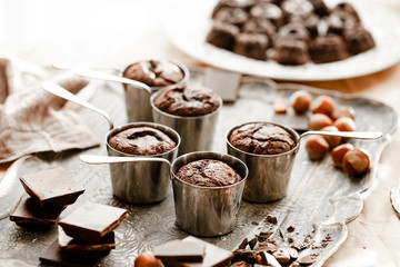 Homemade delicious dark chocolate  fondant cakes. Served in vintage ladles. Delicious elegant dessert for sweet-tooth, sweet breakfast. Romantic atmosphere, aromatherapy. Close up, macro