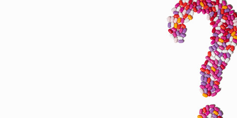 question mark of colored pills on a white background. colored pills isolated on white. empty space for your text
