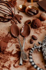 Delicious homemade chocolate preparation process. Vintage kitchen tableware. Intense brown color, aromatherapy. Dark and moody, macro, flat lay, top view