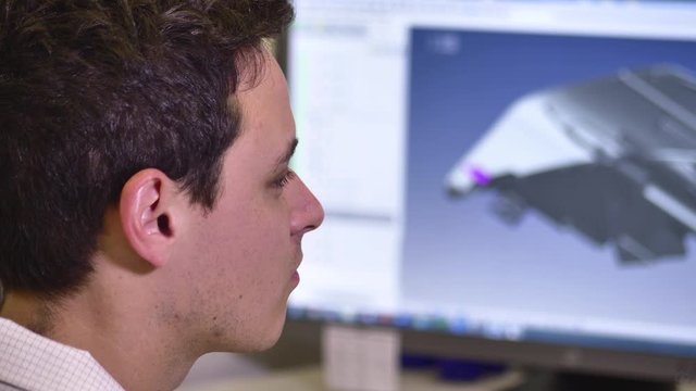 Professional Design Engineer Working on Desktop Computer, Screen Showing CAD Software with 3D Plastic Component for Automotive, Close up