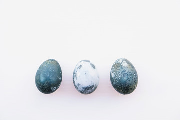 Natural dyed blue colored eggs on white background.