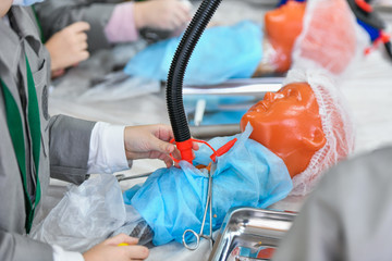 Training operation on a mannequin, closeup. Interest in medicine in children. Children in medical...