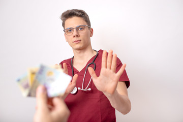 Young doctor refusing bribe in exchange for his services