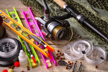 fishing tackle on a wooden table. toned image