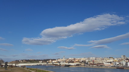 Fototapeta na wymiar Panorama of the city by the river and the bridge