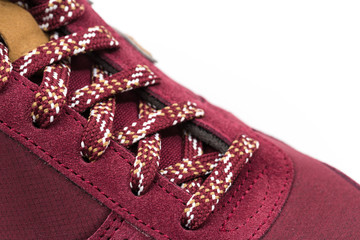 a pair of new burgundy, cherry sneakers or athletic shoes isolated on a white background.