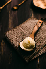 Homemade vanilla ice cream on wooden table with vintage cutlery