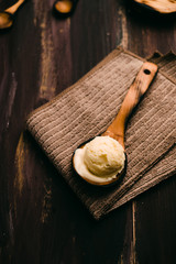 Homemade vanilla ice cream on wooden table with vintage cutlery