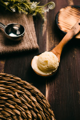 Homemade vanilla ice cream on wooden table with vintage cutlery
