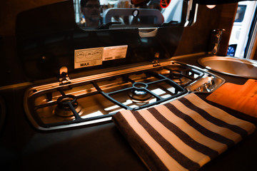 Interior of luxury caravan. Detail photo of coach with equipment.Kitchen