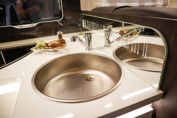 Interior of luxury caravan. Detail photo of coach with equipment.Kitchen