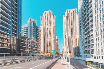 Fototapeta na wymiar Hotel buildings in Dubai Marina district with city street at foreground