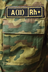 A sign with the designation of the blood group on the military uniform.