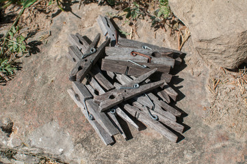 Pile of weathered wooden laundry clamps closeup