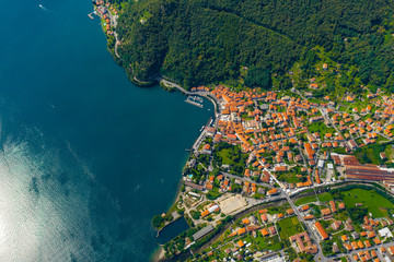 Aerial view of Como lake, Dongo, Italy. Coastline is washed by blue turquoise water