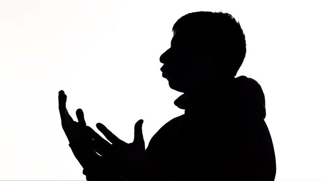 silhouette of a young man talking and gesticulate, creative person explaining idea on white isolated background, concept lifestyle