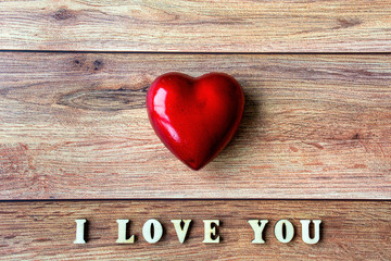 Red heart and text I Love You on wooden background. Valentine's day, mother's day, birthday, celebration concept