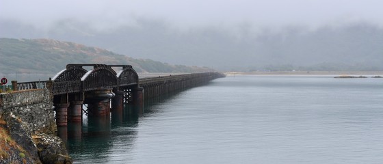 Barmouth railway bridge over the Mawddach in Wales on a cloudy day