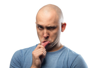 Photo of young bald offended man in blue tee shirt