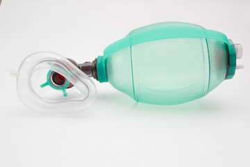 Green AMBU bag with respiratory support mask isolated at the white background