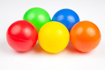 Colored plastic balls on white background. leisure and game items. round objects