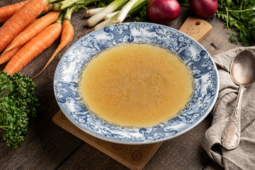 Chicken bone broth in a blue vintage plate