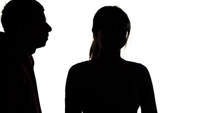 silhouette of young man and woman flirting,girl kisses a guy earlier than he in lips, concept love and romantic feelings