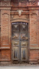 antique door brown wooden with square ornaments in a light wall